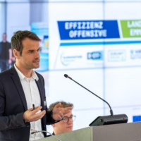 KEFF+Moderator Fabian Delong zeigt beim Wirtschaftsbankett auf, welche kostenfreien Angebote die Effizienz-Offensive anbietet.